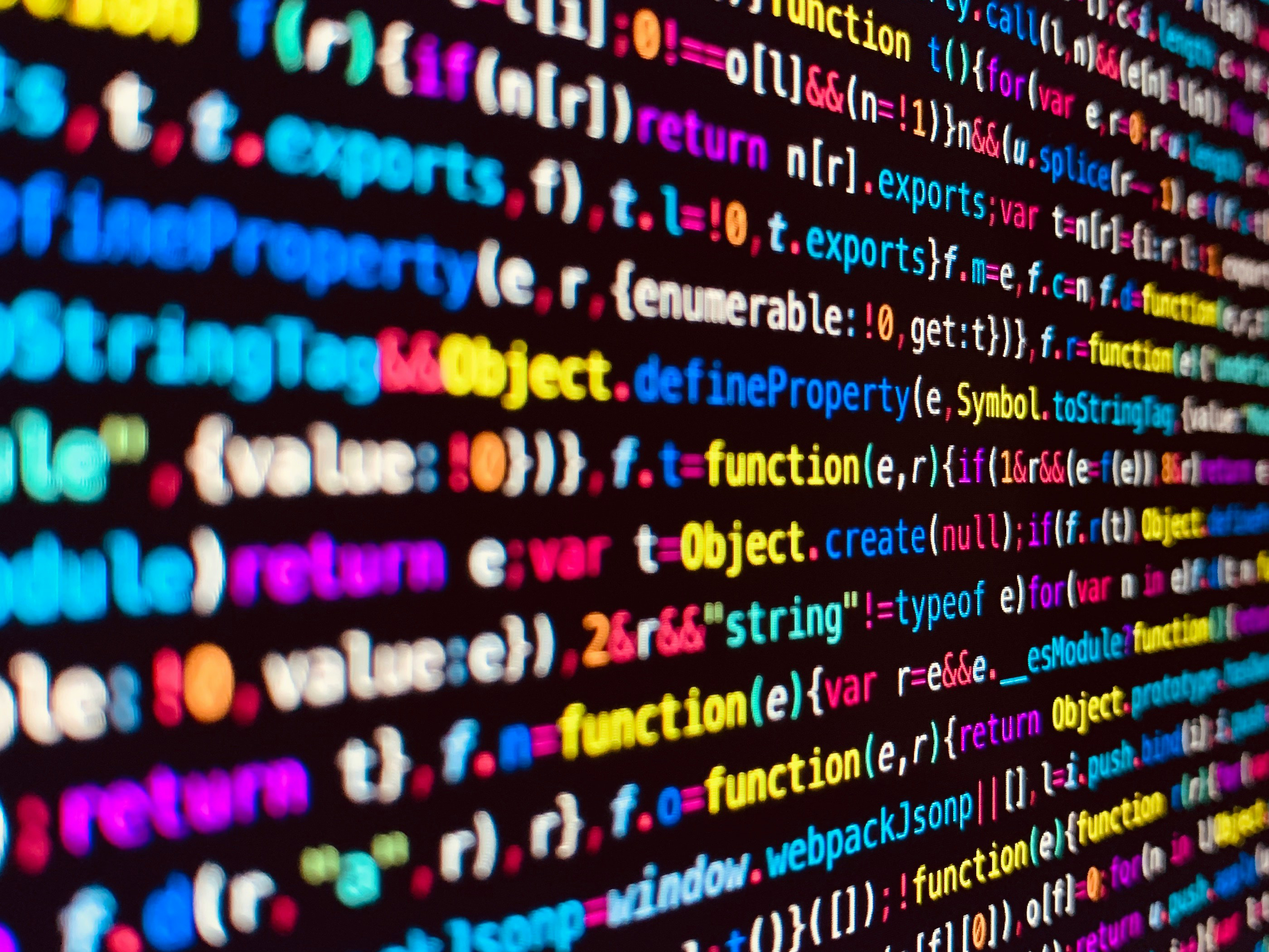 computer screen with multicolored minified code